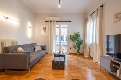 a living room with a couch and a television at Acropolis View Rooftop Garden & Jacuzzi in Athens