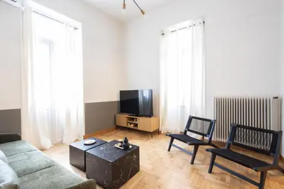 a living room with a couch and a tv at Acropolis View Rooftop Garden & Jacuzzi in Athens