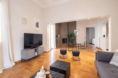 a living room with a couch and a flat screen tv at Acropolis View Rooftop Garden & Jacuzzi in Athens