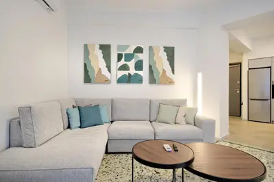 a living room with a couch and a table at Modern Corner Apartment in Central Athens, Pagrati in Athens