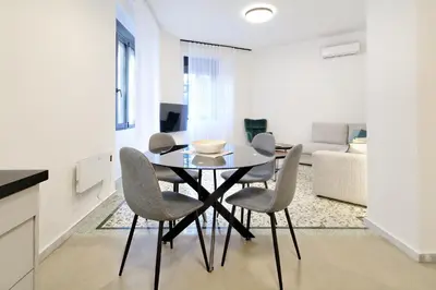 a dining room table and chairs in a living room at Modern Corner Apartment in Central Athens, Pagrati in Athens