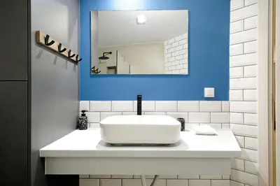 a bathroom with a white sink and a mirror at Modern Corner Apartment in Central Athens, Pagrati in Athens