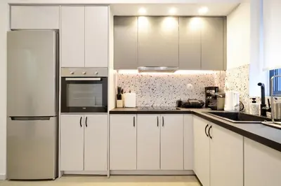 a kitchen with white cabinets and a refrigerator at Modern Corner Apartment in Central Athens, Pagrati in Athens