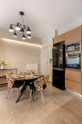 a dining room with a table and chairs in a kitchen at Alfalfa Pagrati - Stylish Apartment near Caravel & Center in Athens