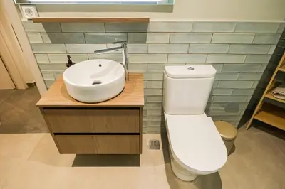 a bathroom with a white toilet and a sink at Alfalfa Pagrati - Stylish Apartment near Caravel & Center in Athens