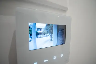 a television with a picture of a house at Odysseas Palace in Athens in Athens