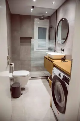 a bathroom with a toilet sink and a washing machine at CHIC and MODERN THISSIOs APARTMENT in Athens