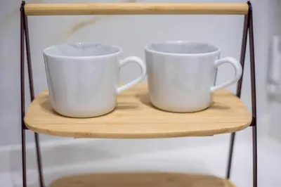two white coffee mugs sitting on a shelf at CHIC and MODERN THISSIOs APARTMENT in Athens