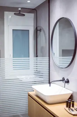 a bathroom with a white sink and a mirror at CHIC and MODERN THISSIOs APARTMENT in Athens
