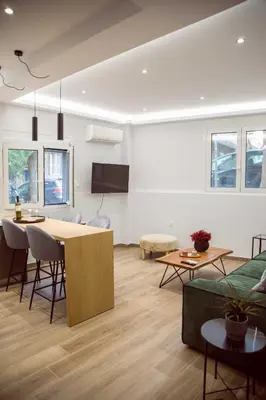 a living room with a table and a couch at CHIC and MODERN THISSIOs APARTMENT in Athens
