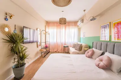 a living room with a bed and a couch at Hellinikos Suite - few steps from Acropolis in Athens