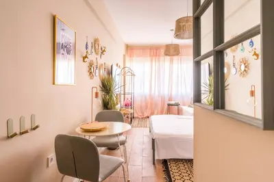 a living room with a table and chairs at Hellinikos Suite - few steps from Acropolis in Athens