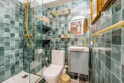 a bathroom with a toilet and a glass shower at Hellinikos Suite - few steps from Acropolis in Athens