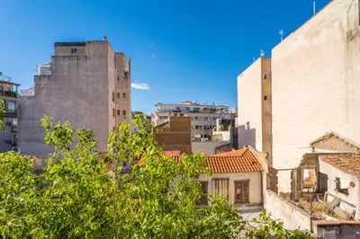 a view of a city with tall buildings and trees at Hellinikos Suite - few steps from Acropolis in Athens