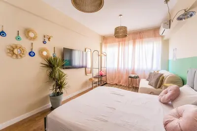 a room with two beds and a couch at Hellinikos Suite - few steps from Acropolis in Athens