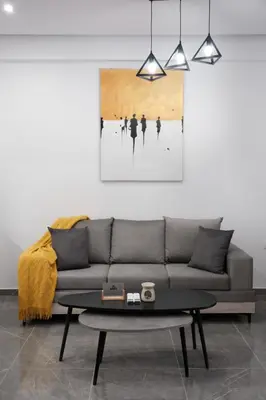a living room with a couch and a table at Cozy Home With Cooking in Piraeus