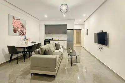 a living room with a couch and a table at Cozy Home With Cooking in Piraeus
