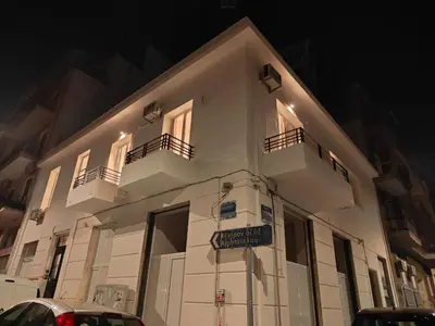 a white building with two balconies and a street sign at Marilyn Residence II in Athens