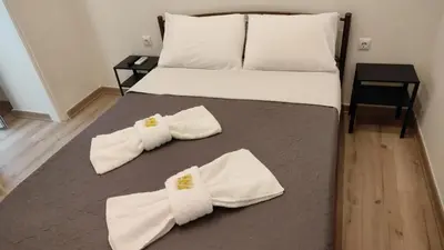 a bed with white pillows and towels on it at Marilyn Residence II in Athens