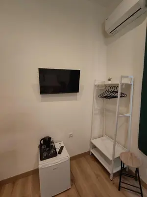 a room with a flat screen tv on a wall at Marilyn Residence II in Athens