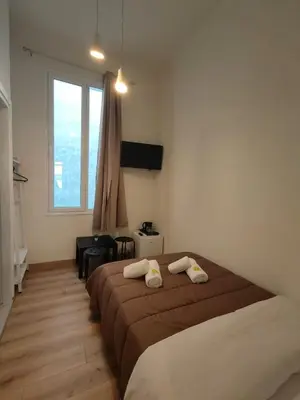 a bedroom with a bed with two towels on it at Marilyn Residence II in Athens