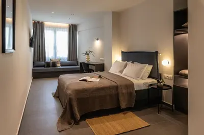 a hotel room with a bed and a couch at Celestial Athens Suites at Praxitelous in Athens