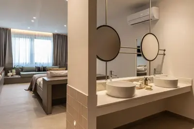a bathroom with two sinks and a large mirror at Celestial Athens Suites at Praxitelous in Athens