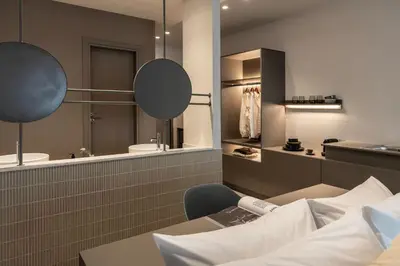 a hotel room with a bed and a bathroom at Celestial Athens Suites at Praxitelous in Athens