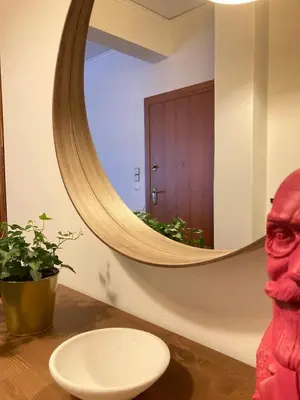 a bathroom with a round mirror and a sink at Kallithea Nest by Mancris in Athens