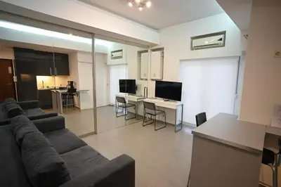 a living room with a couch and a table with chairs at Kolonaki Xanthipou 7-9 by Zeussuites in Athens