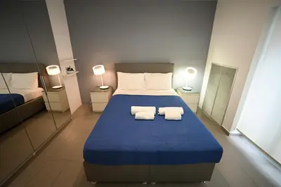 a bedroom with a bed with two towels on it at Kolonaki Xanthipou 7-9 by Zeussuites in Athens
