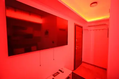 a red room with a sink and a mirror at Hermes Suite Klathmonos by Zeussuites in Athens