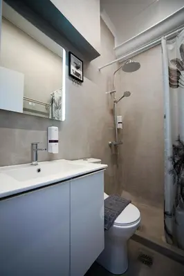 a bathroom with a sink and a toilet and a shower at Hermes Suite Klathmonos by Zeussuites in Athens