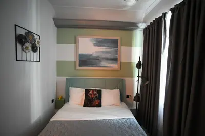 a bedroom with a bed with a pillow on it at Hermes Suite Klathmonos by Zeussuites in Athens