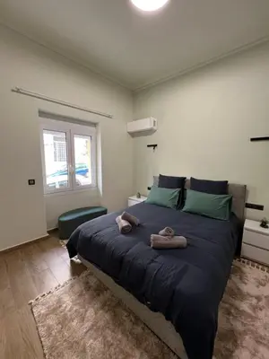 a bedroom with a large bed with towels on it at Cozy and modern apartment in Athens