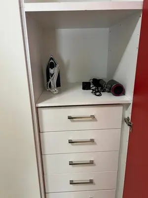 a closet with a dresser with a camera on it at Cozy and modern apartment in Athens