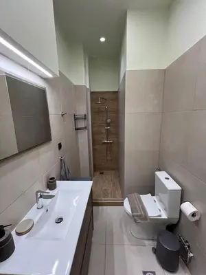 a bathroom with a sink and a toilet and a shower at Cozy and modern apartment in Athens
