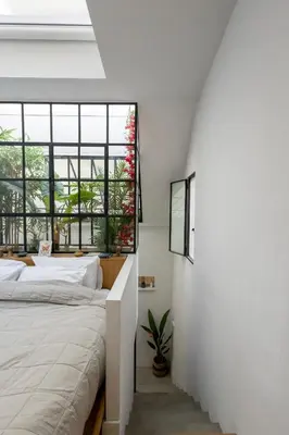 a bedroom with a bed and a window at The loft in Athens
