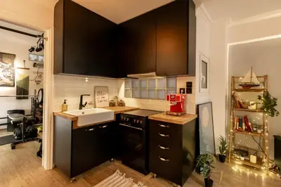 a kitchen with black cabinets and a sink at The loft in Athens