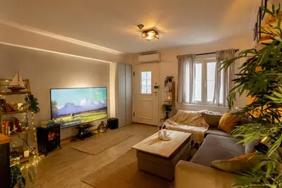 a living room with a couch and a tv at The loft in Athens