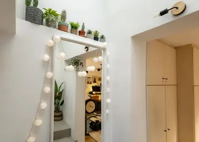 a room with white walls and a door with plants at The loft in Athens