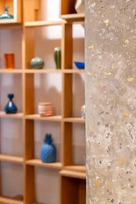 a book shelf with vases on it with glass at Historic 2BR Oasis in Kolonaki in Athens