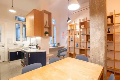 a kitchen and dining room with a table and chairs at Historic 2BR Oasis in Kolonaki in Athens