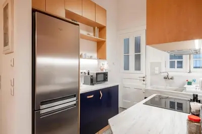 a kitchen with a stainless steel refrigerator at Historic 2BR Oasis in Kolonaki in Athens