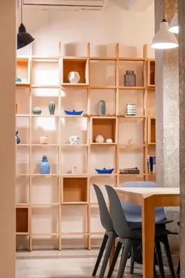 a dining room with wooden shelves and a table and chairs at Historic 2BR Oasis in Kolonaki in Athens
