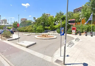 a park with a fountain in the middle of a street at Modern Comfort Minutes from Plaka & Monastiraki in Athens