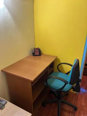 a desk with a blue chair in a room at Modern Comfort Minutes from Plaka & Monastiraki in Athens