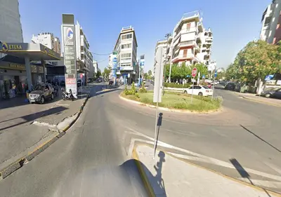 an empty street in a city with tall buildings at Modern Comfort Minutes from Plaka & Monastiraki in Athens