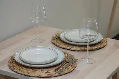 a table with plates and wine glasses on a table at Athens Luxury center Aparts F&G in Athens