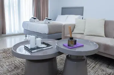 a hotel room with a bed and a couch and tables at Athens Luxury center Aparts F&G in Athens